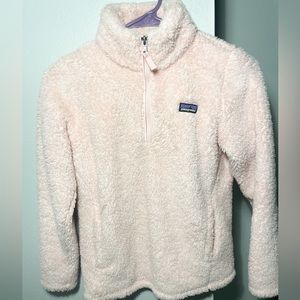 Light pink Patagonia sweater.